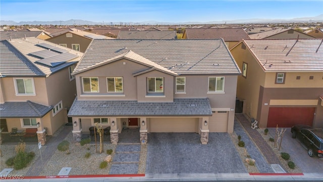 view of front of house featuring a garage and a mountain view