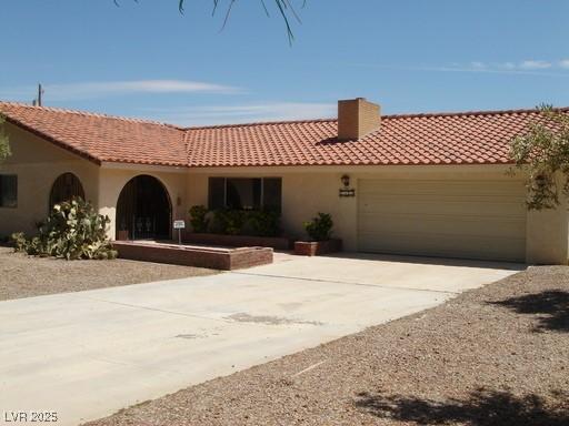 mediterranean / spanish home with a garage