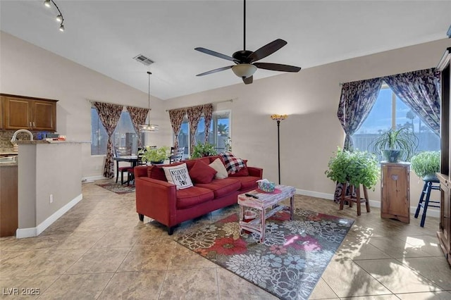 tiled living room with ceiling fan and lofted ceiling