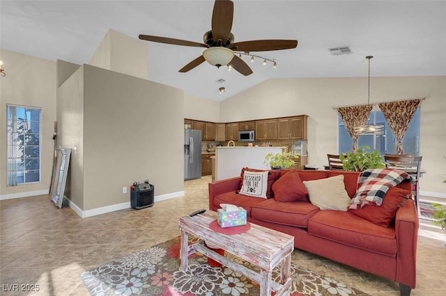 tiled living room with ceiling fan and lofted ceiling