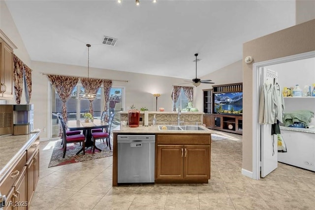 kitchen with a center island, lofted ceiling, pendant lighting, stainless steel dishwasher, and sink