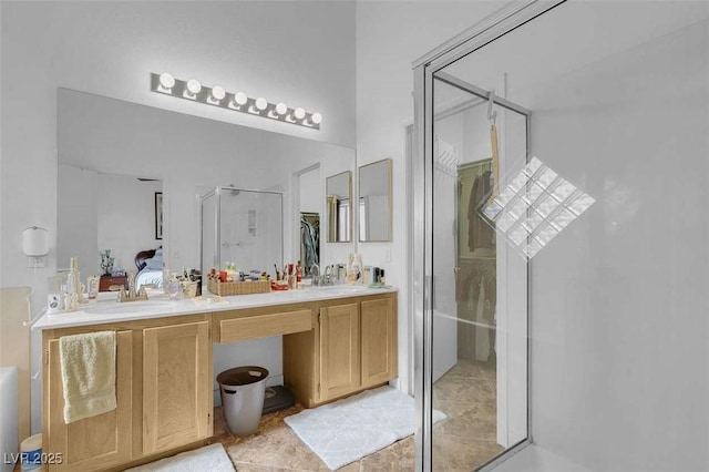 bathroom featuring tile patterned flooring, an enclosed shower, and vanity