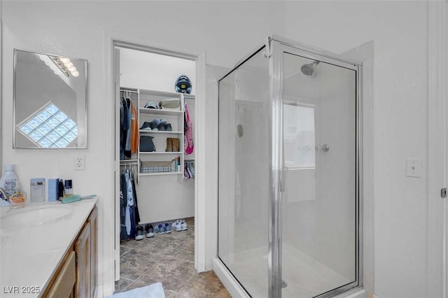 bathroom with walk in shower and vanity