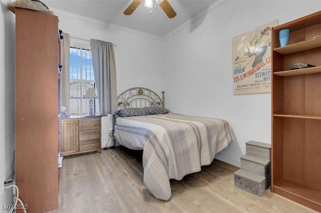 bedroom with ceiling fan, hardwood / wood-style flooring, and crown molding