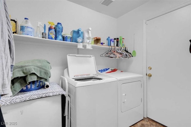 clothes washing area with washing machine and dryer