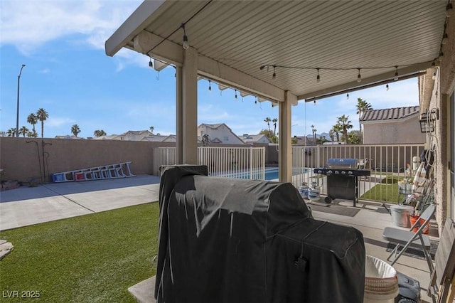 view of patio / terrace with a fenced in pool and area for grilling