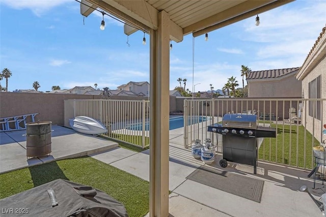 view of patio / terrace featuring grilling area and a fenced in pool