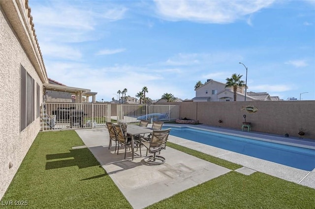 view of swimming pool featuring a patio area and a yard