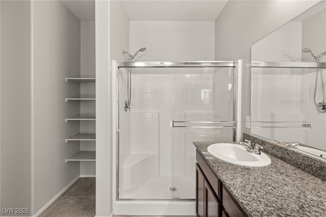 bathroom featuring an enclosed shower and vanity