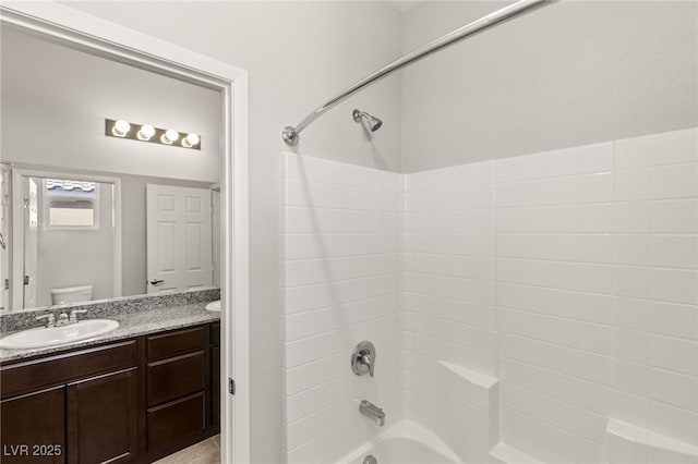 full bathroom with toilet, vanity, and bathtub / shower combination