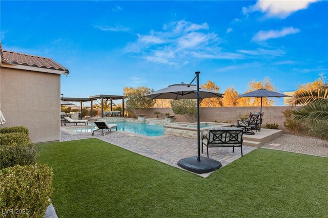 view of swimming pool with an in ground hot tub, pool water feature, a yard, a pergola, and a patio