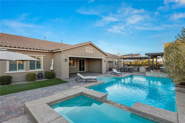 view of swimming pool with a patio area and an in ground hot tub