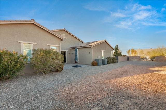 view of side of property featuring central AC