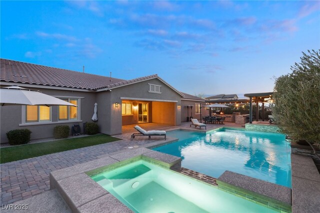 view of swimming pool with an in ground hot tub and a patio