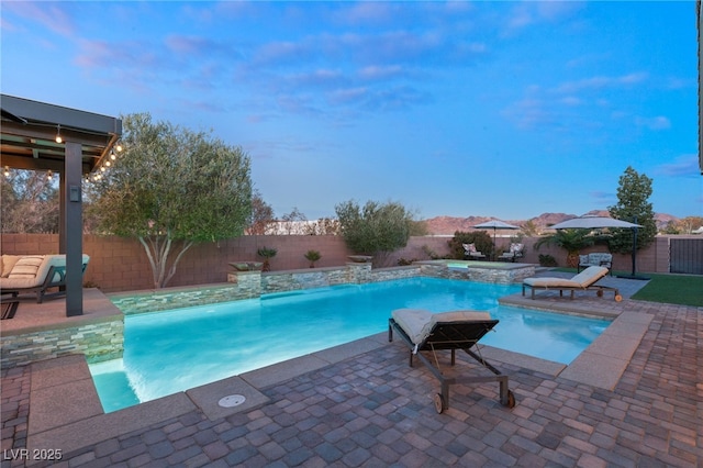 view of pool featuring pool water feature and a patio