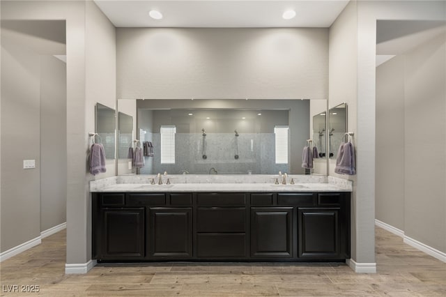 bathroom featuring walk in shower, hardwood / wood-style floors, and vanity