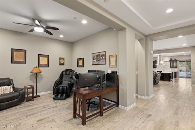 office with ceiling fan and light hardwood / wood-style flooring