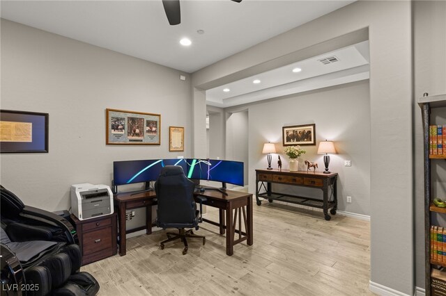 office space with ceiling fan and light hardwood / wood-style floors