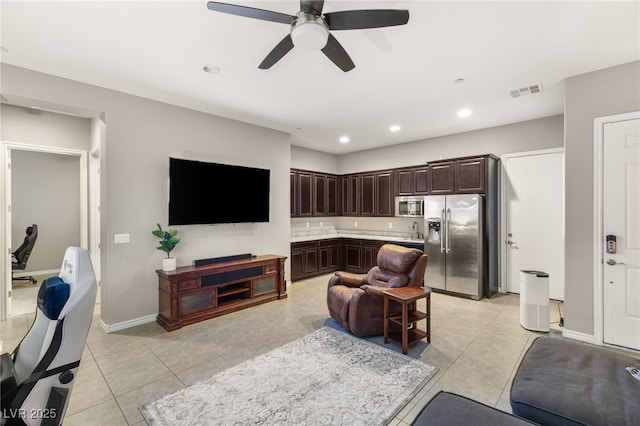 living room featuring ceiling fan and light tile patterned flooring