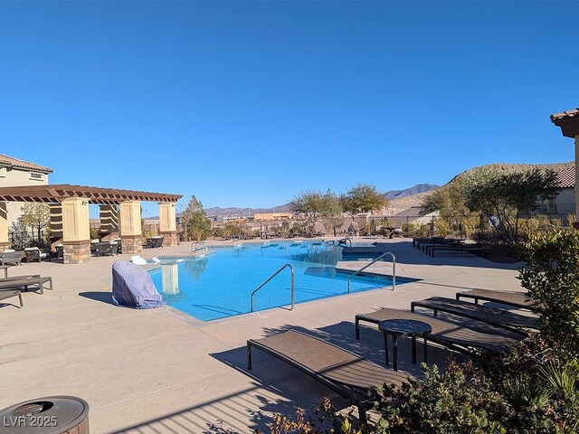 view of pool with a mountain view, a pergola, and a patio