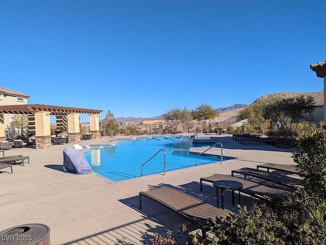 view of swimming pool featuring a mountain view, a pergola, and a patio area