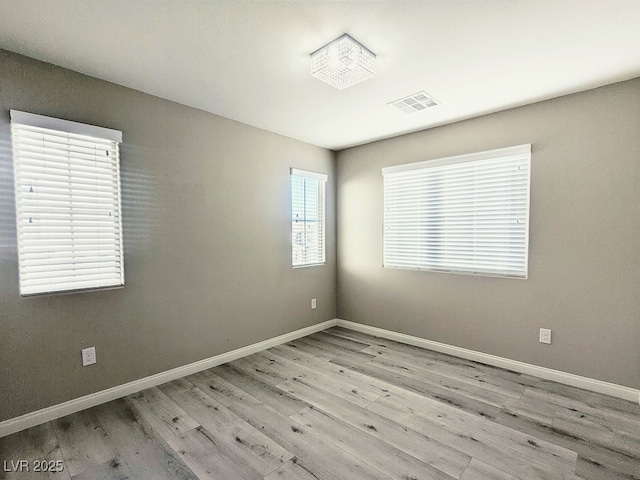 spare room featuring light hardwood / wood-style floors