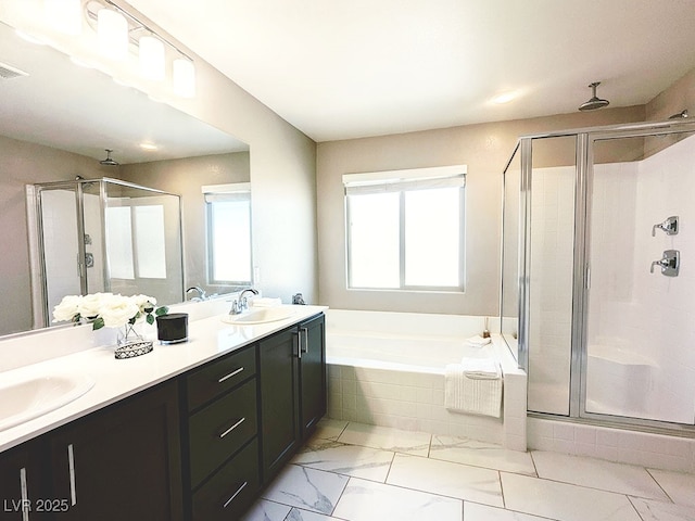 bathroom featuring separate shower and tub and vanity