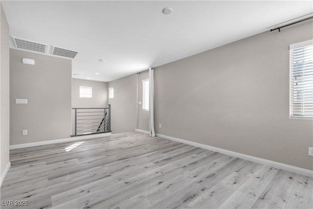 spare room featuring light wood-type flooring