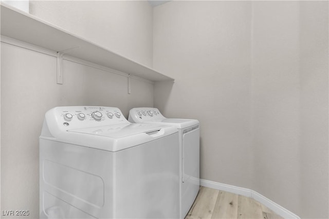 laundry area featuring separate washer and dryer and light wood-type flooring