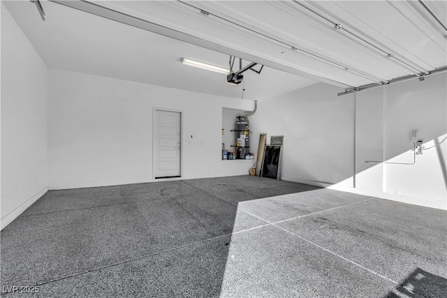 garage featuring a garage door opener and water heater