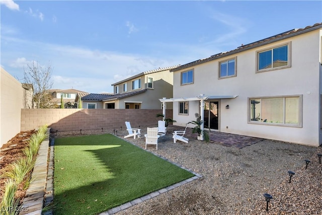 back of house featuring a yard, a pergola, and a patio area