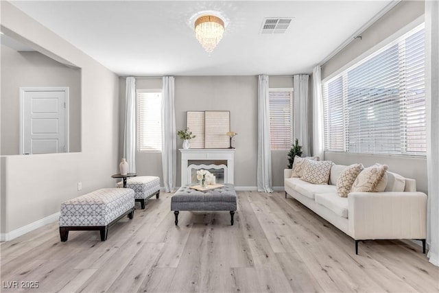 sitting room featuring an inviting chandelier and light hardwood / wood-style floors