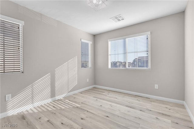 spare room with light wood-type flooring