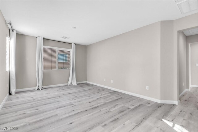 empty room featuring plenty of natural light and light hardwood / wood-style flooring