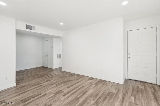 unfurnished room with light hardwood / wood-style flooring