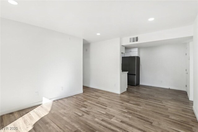 unfurnished living room featuring wood-type flooring