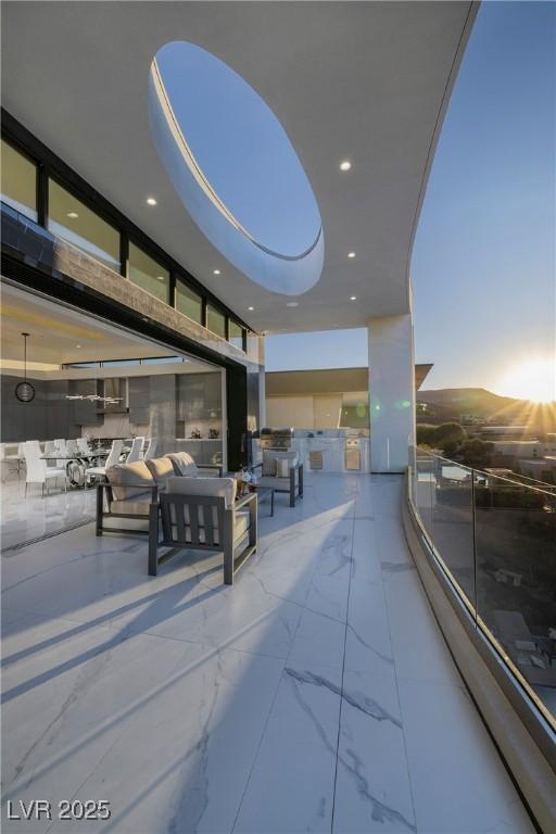 patio terrace at dusk featuring an outdoor hangout area