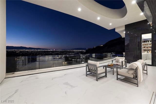 patio terrace at dusk featuring outdoor lounge area