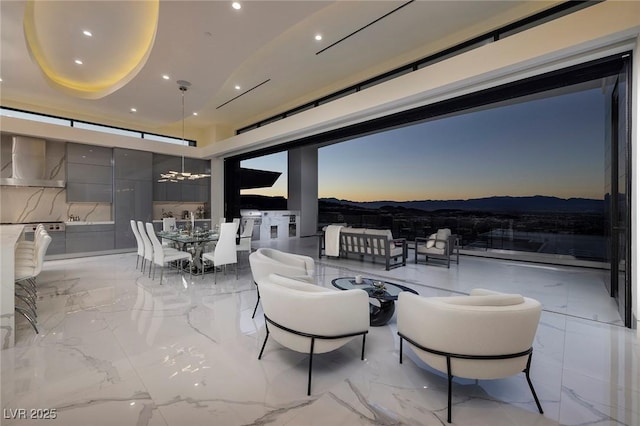 patio terrace at dusk featuring an outdoor hangout area and a mountain view