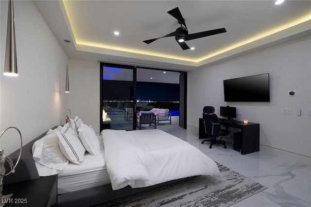 bedroom featuring ceiling fan, access to outside, and a tray ceiling