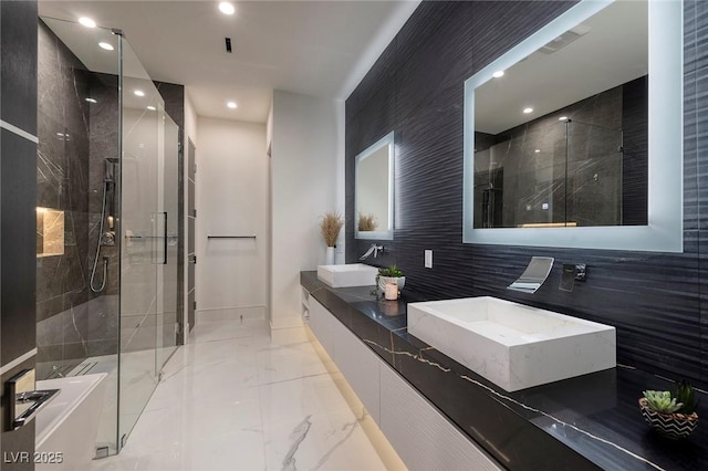 bathroom featuring vanity, tile walls, and a shower with door