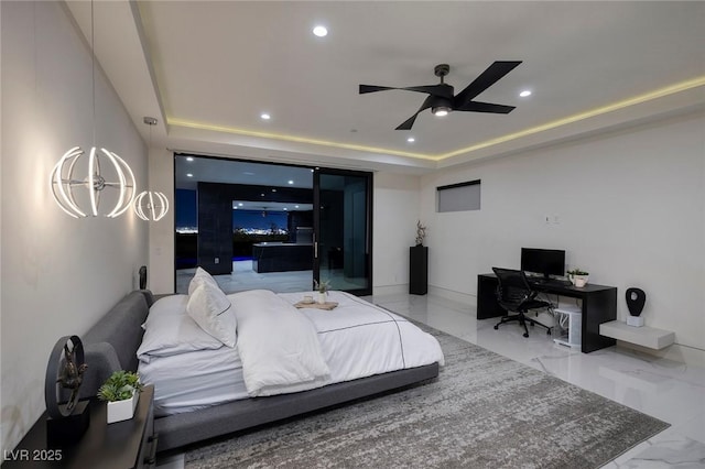 bedroom with ceiling fan and a tray ceiling