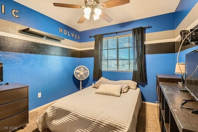 bedroom featuring ceiling fan and carpet