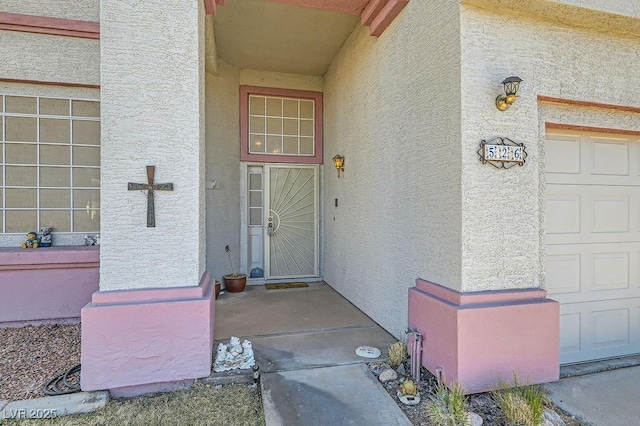 view of exterior entry with a garage