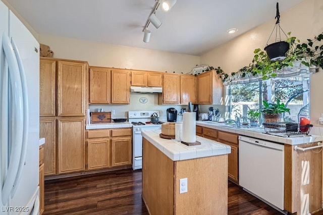 kitchen with tile countertops, a center island, sink, white appliances, and dark wood-type flooring