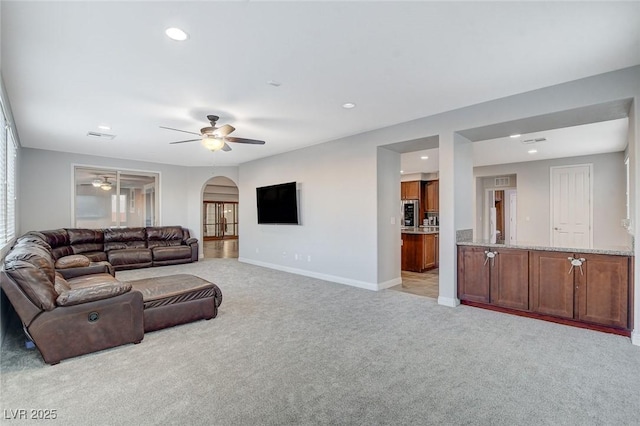 living room with light carpet and ceiling fan