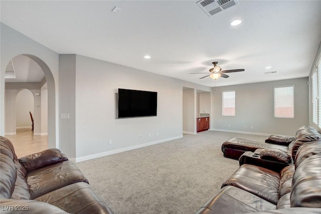 living room featuring ceiling fan and light colored carpet