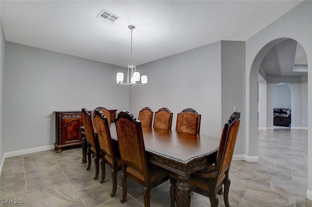 dining area featuring a notable chandelier