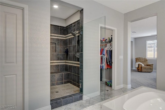 bathroom featuring tiled shower and tile patterned flooring