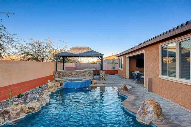 view of pool with a gazebo and an in ground hot tub